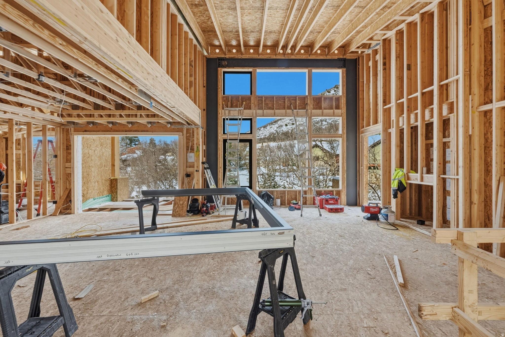 Framed interior featuring high ceilings and large window openings