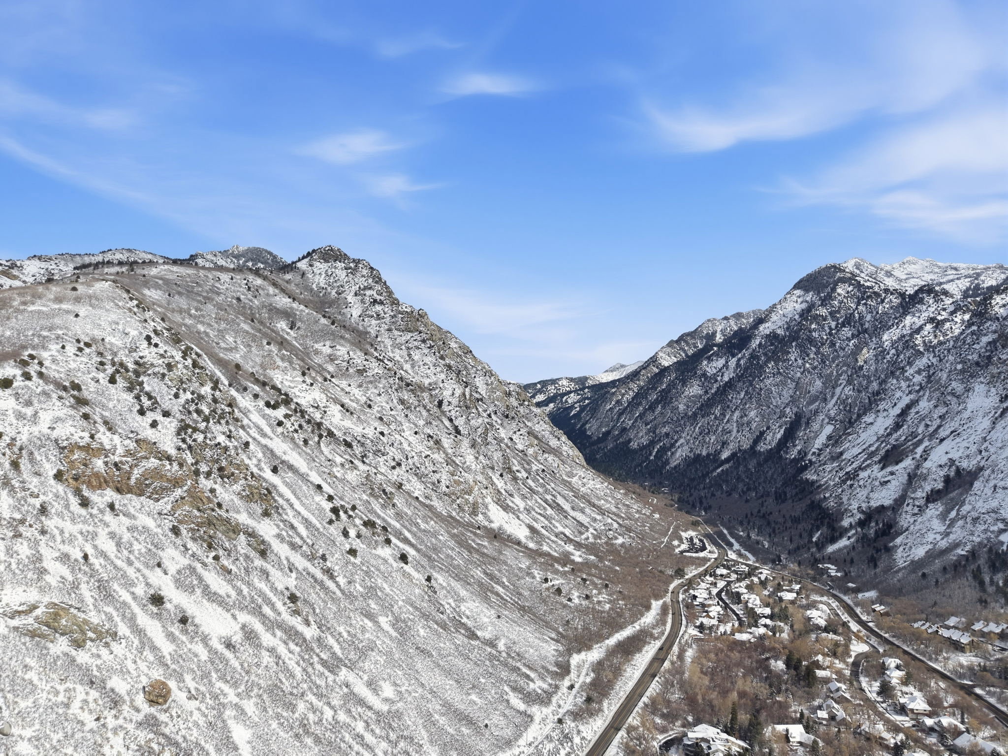 Snow-capped mountain landscape with a valley settlement