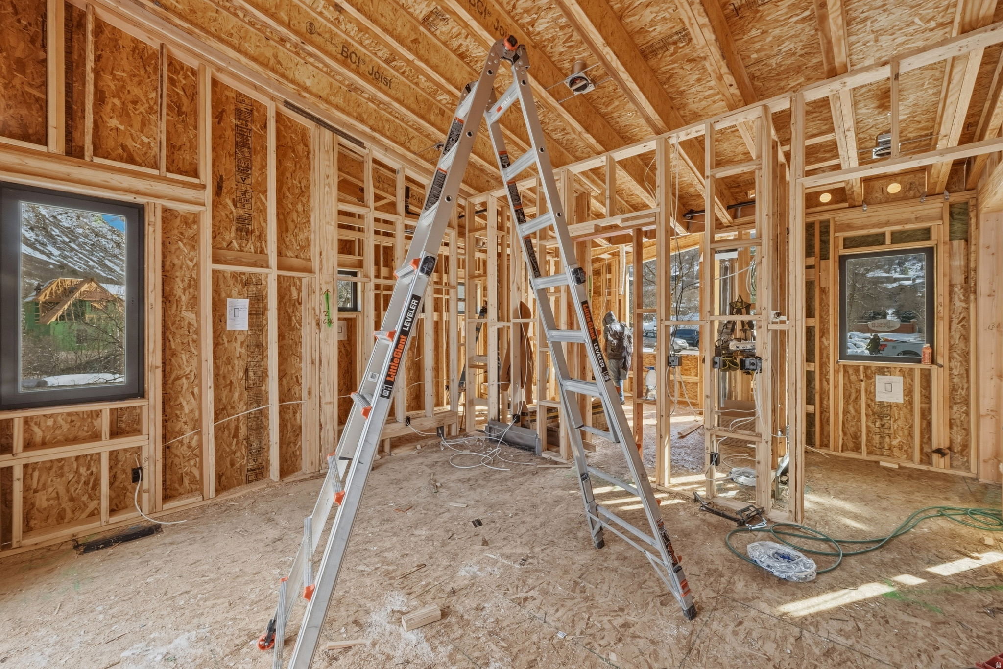 Framed interior space with exposed ceiling joists and wall studs