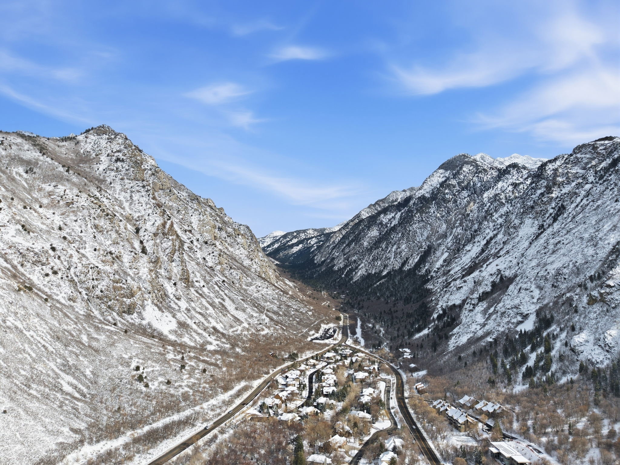 Aerial perspective showcasing a mountain valley setting with snow-dusted peaks