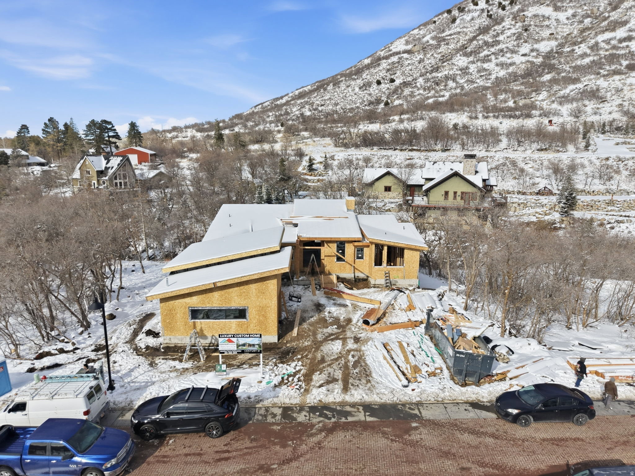 Contemporary construction with multi-pitched roofing and natural wood sheathing