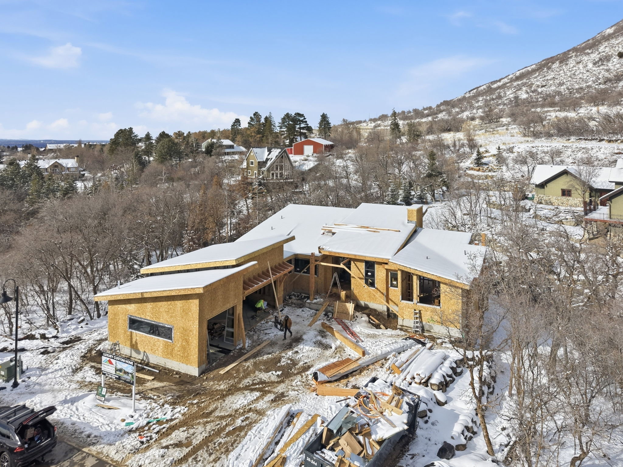 New construction residential property featuring a multi-level design and a partial snow-covered roof