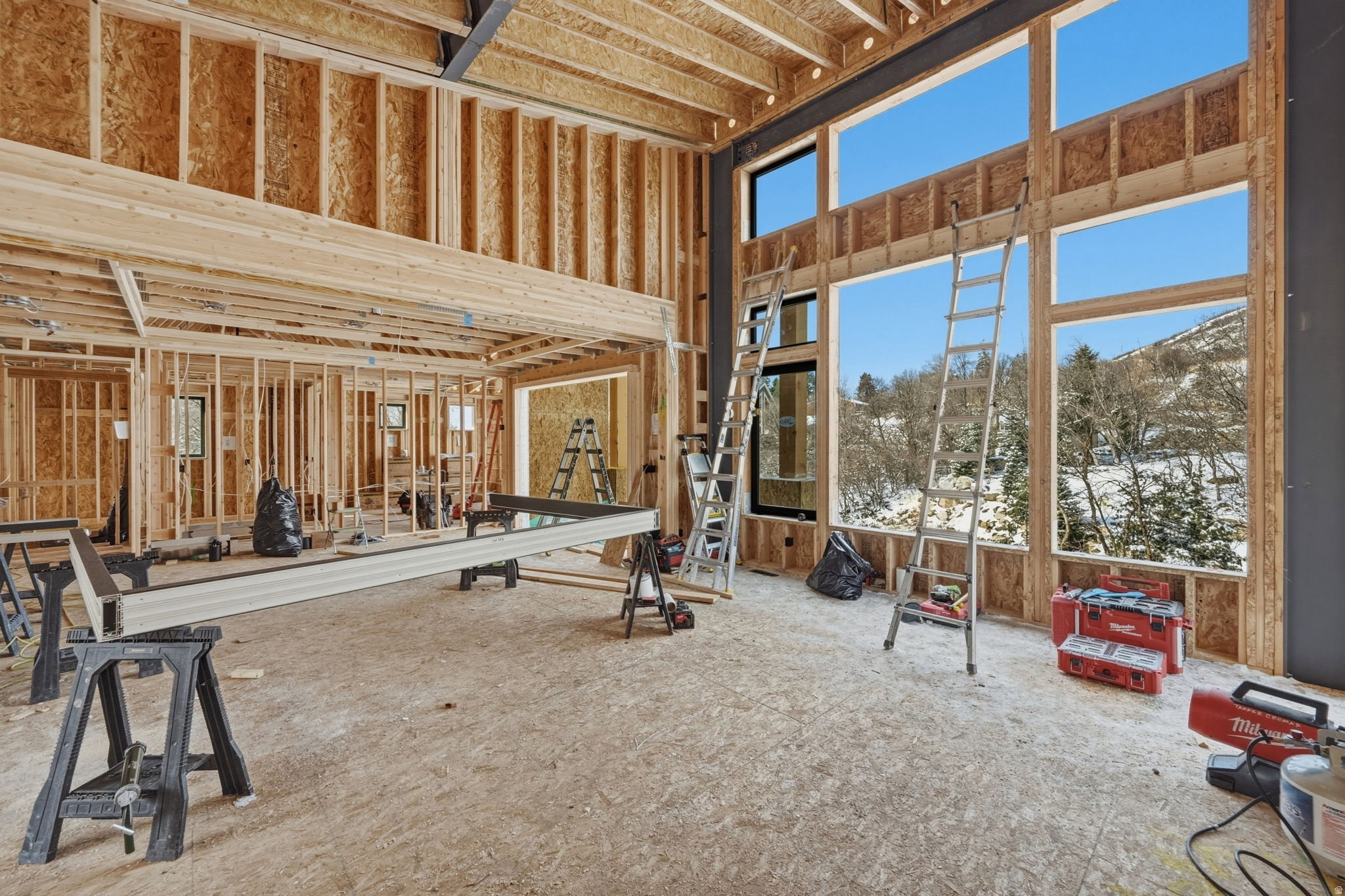 Two-story framing features expansive window openings and a double-height ceiling