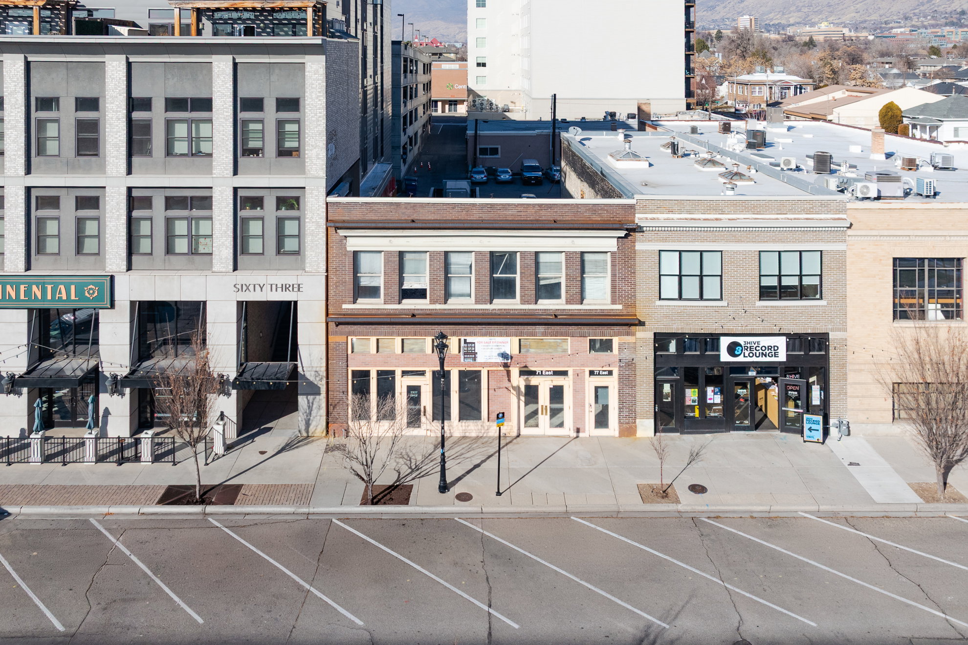 Two-story commercial building featuring a brick facade and multiple large windows