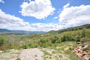 Elevated terrain with distant water features framed by mountains