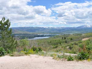 Expansive mountain and lake scenery with distant snow-capped peaks