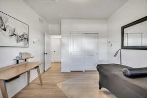 Light wood-finish flooring complements the crisp white walls and white baseboards