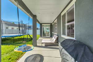 Covered patio featuring a concrete slab and direct backyard access
