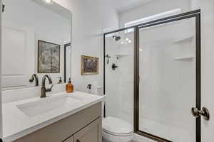 Modern bathroom featuring a single vanity with an integrated sink and light-toned countertop