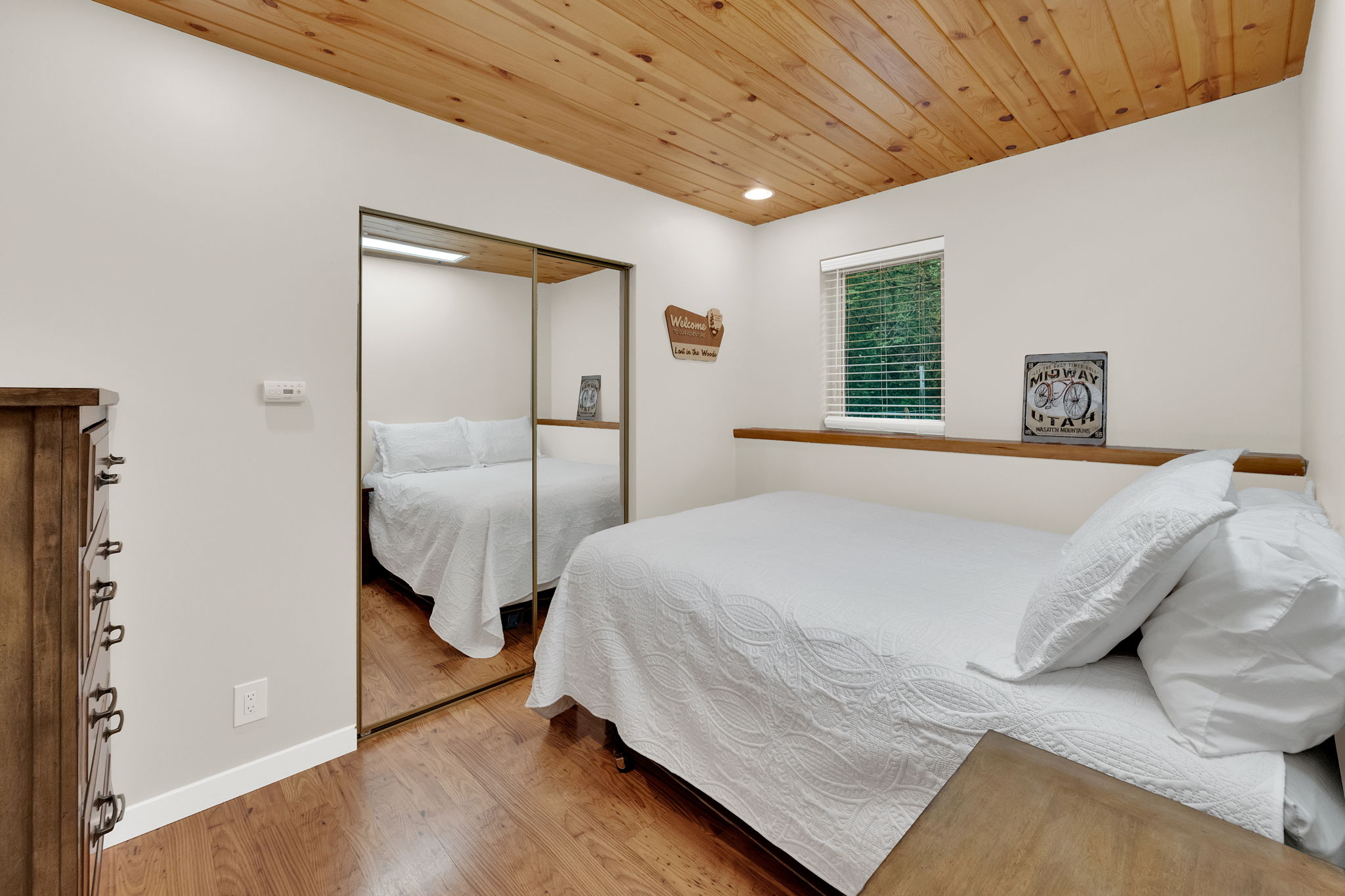 Wood-finish flooring throughout, complemented by a natural wood plank ceiling