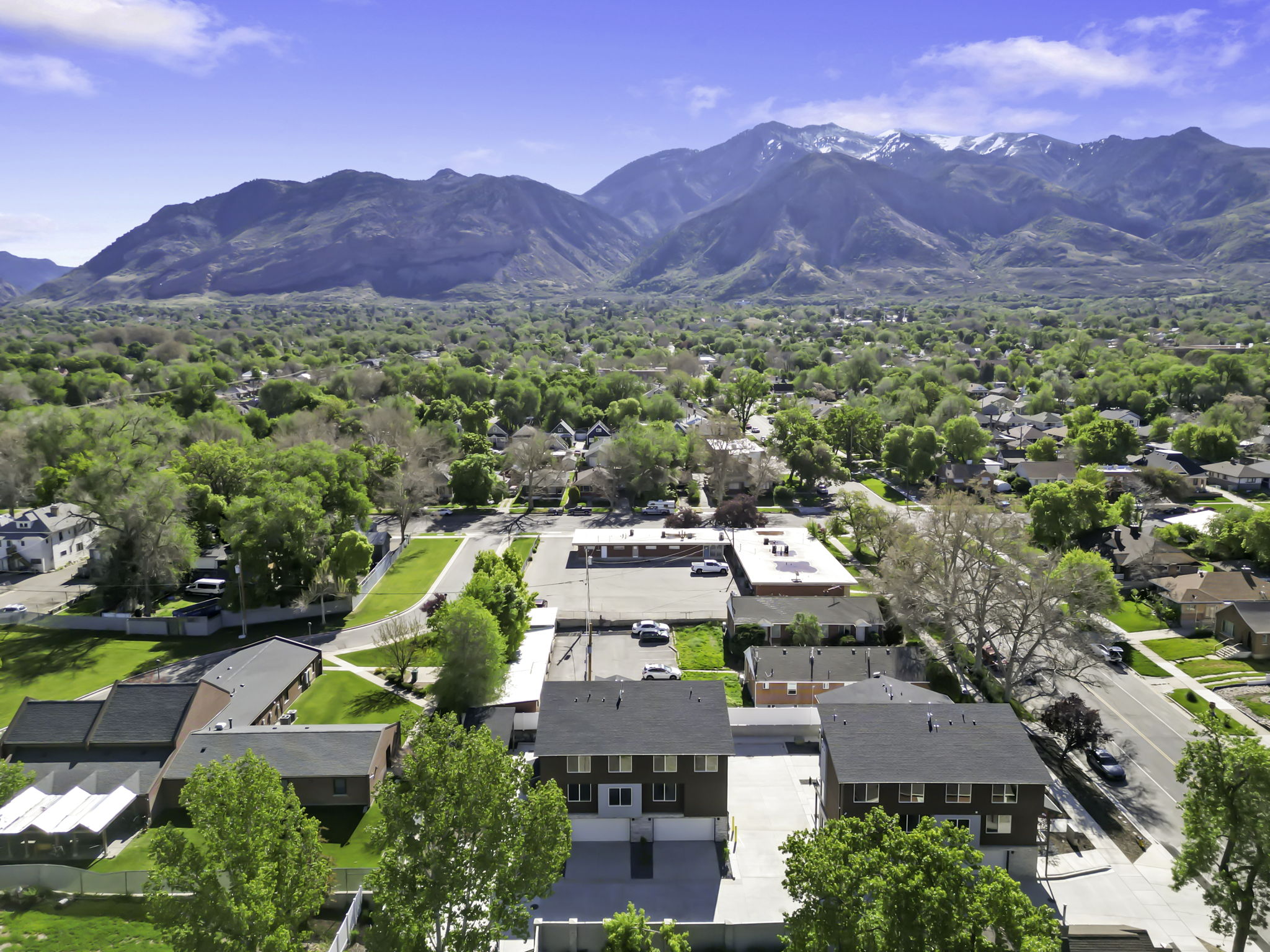 Aerial perspective featuring prominent snow-capped mountains in the background