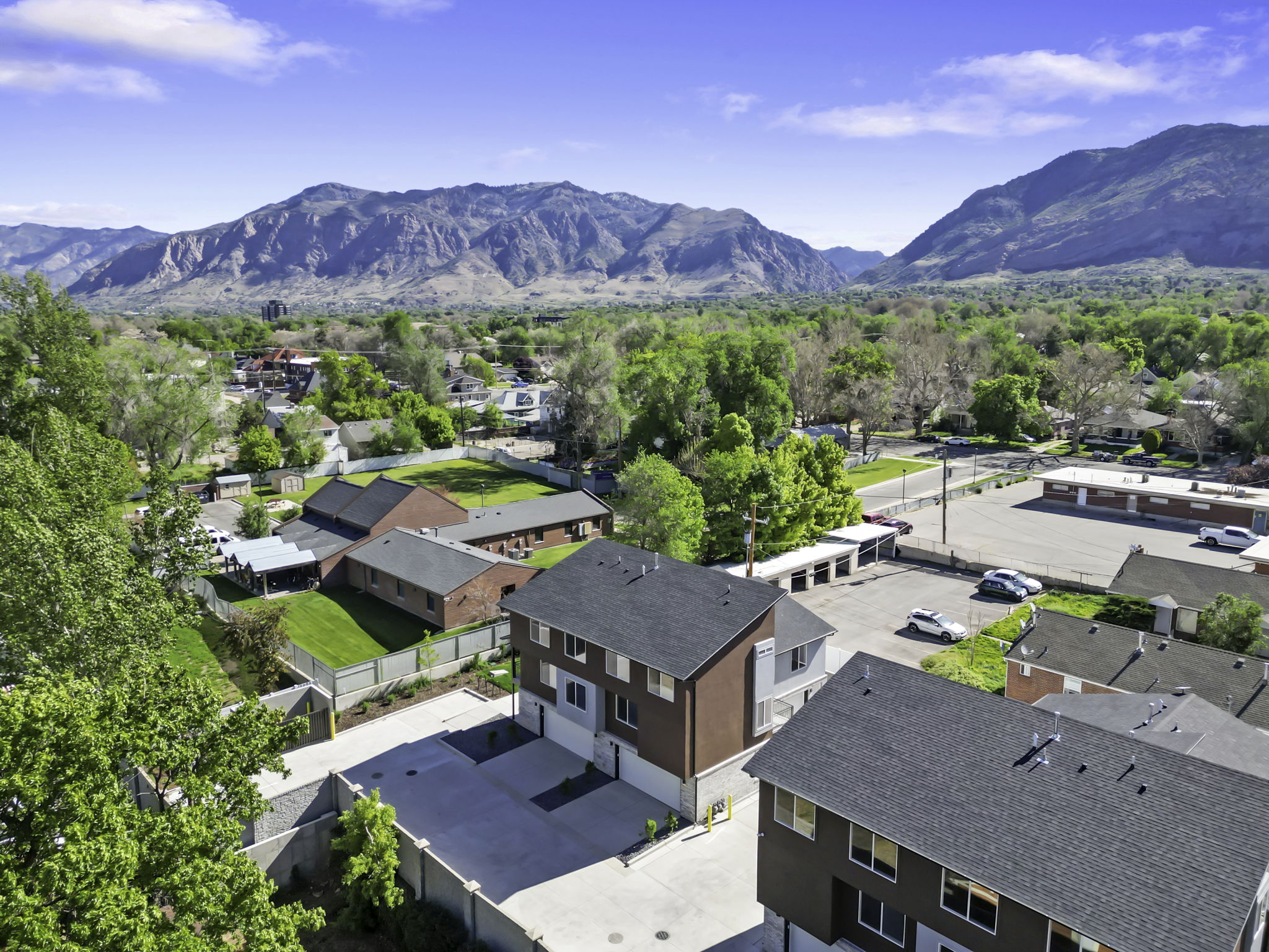 Newly constructed multi-story residential buildings featuring contemporary facades with varied siding materials