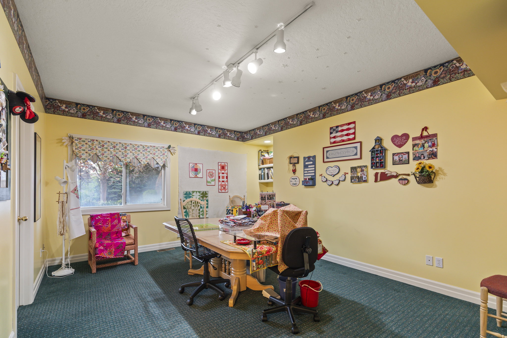 Office area featuring dark carpet and baseboards