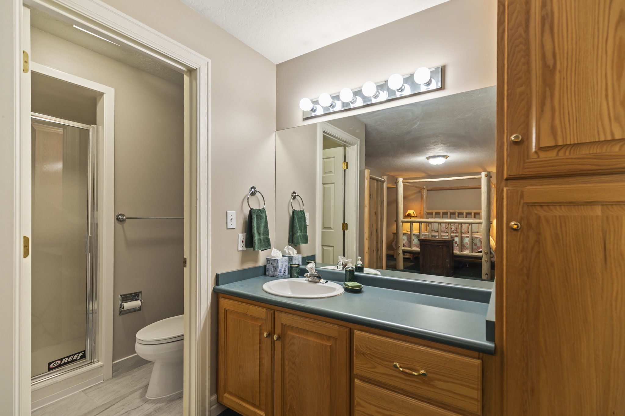 Full bathroom featuring vanity and a shower stall