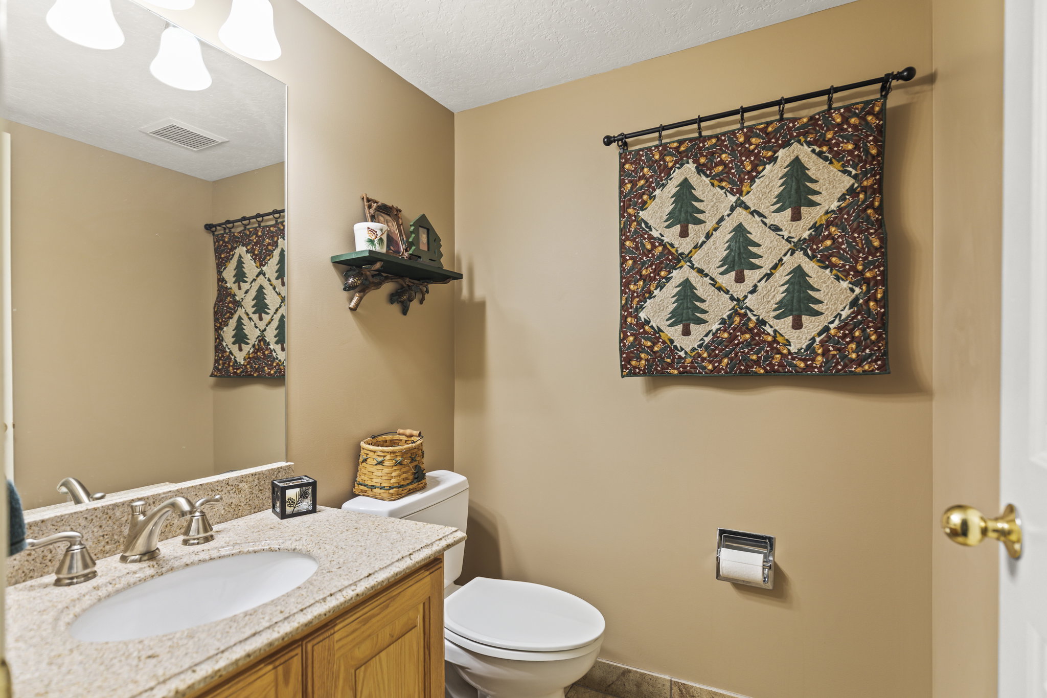 Half bathroom with vanity and a textured ceiling