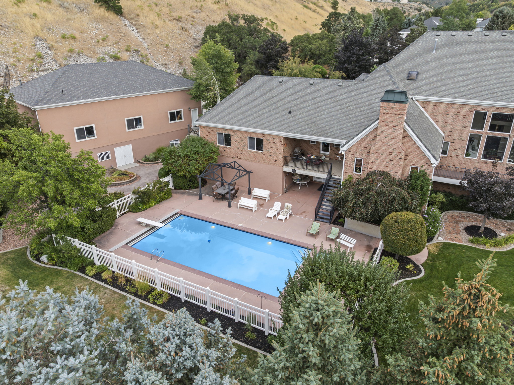 View of swimming pool with patio surround and a fenced backyard