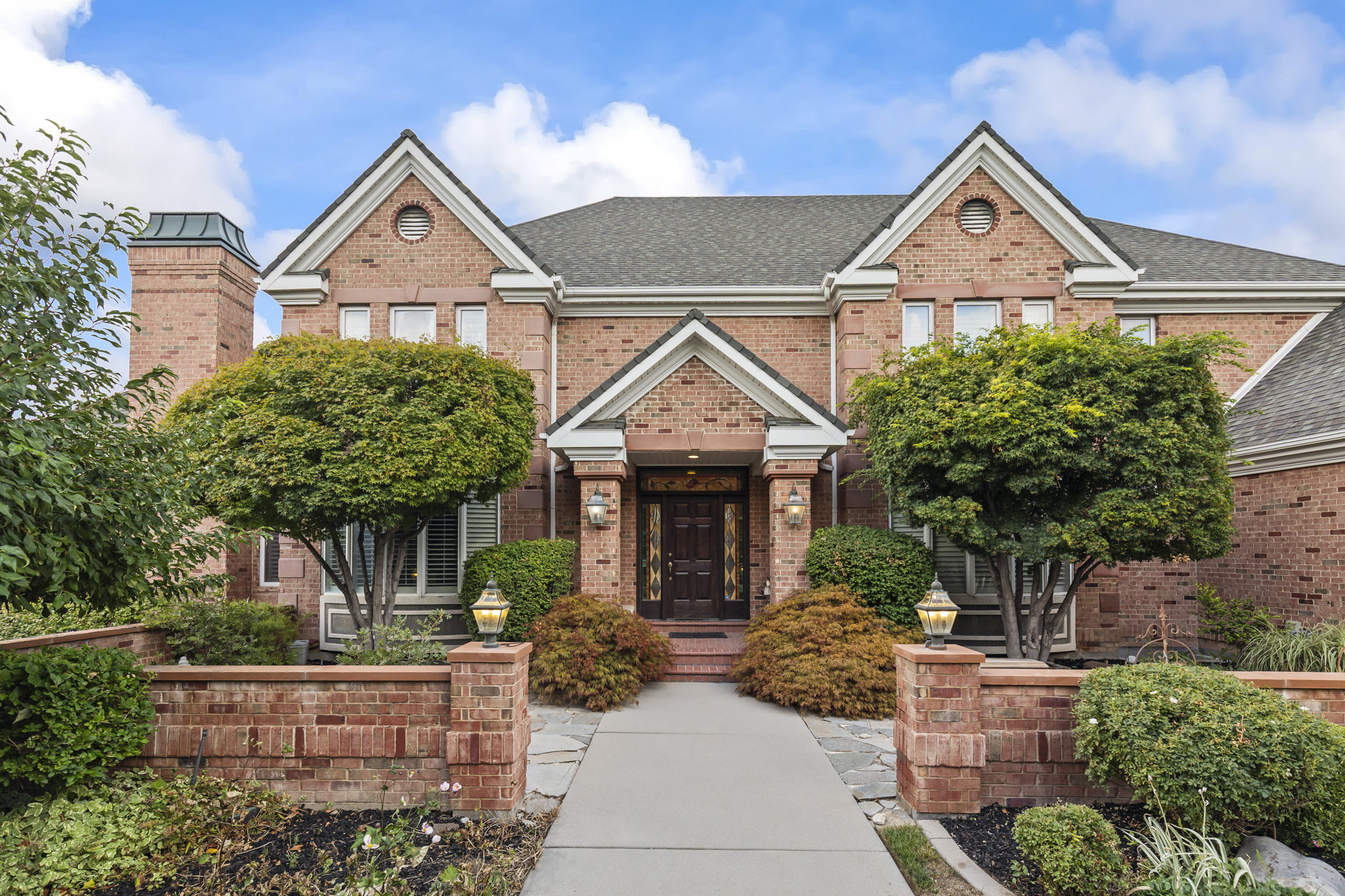 Traditional-style house featuring brick siding and a shingled roof