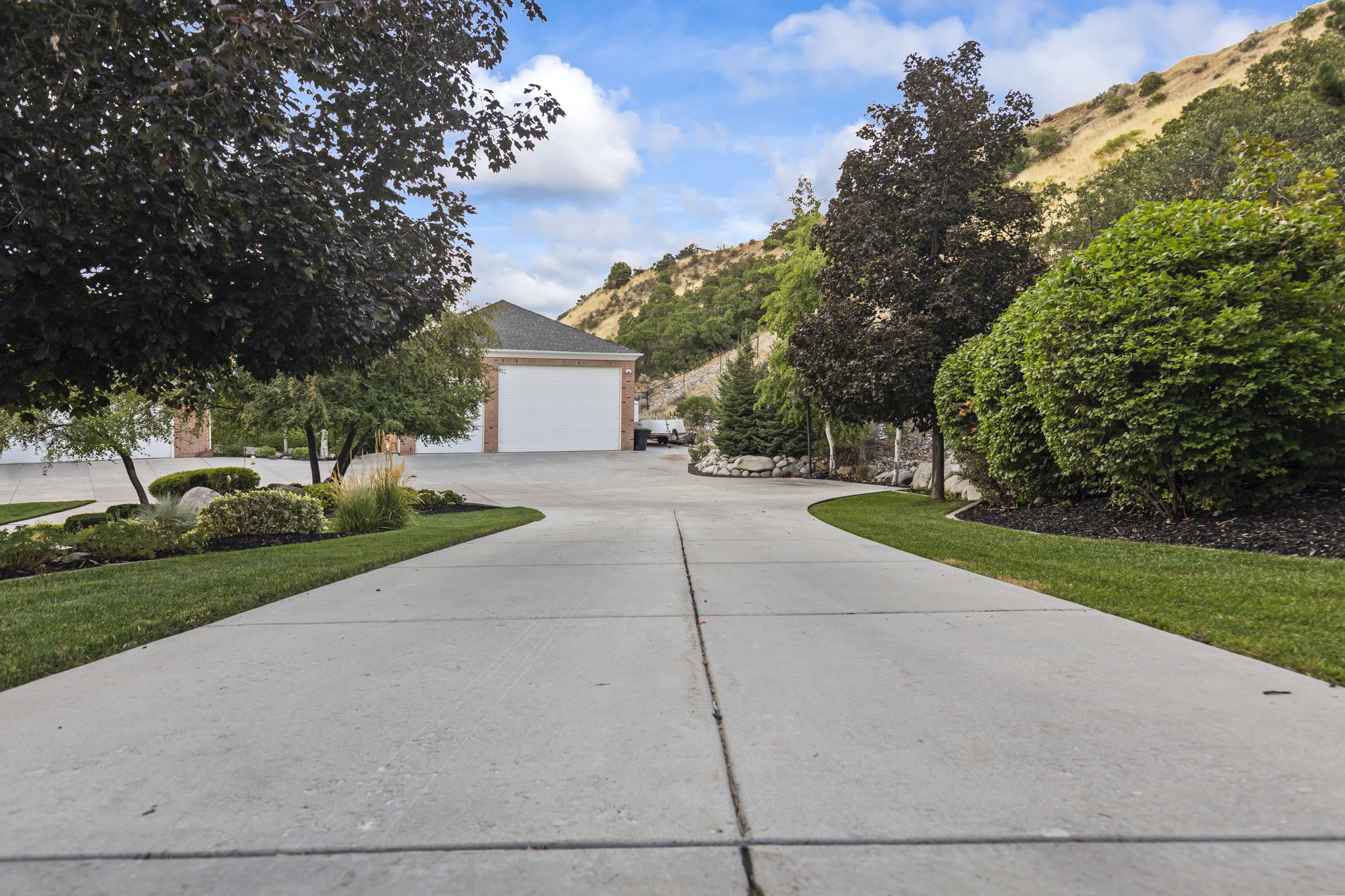 View of front of home with concrete driveway and a mountain view