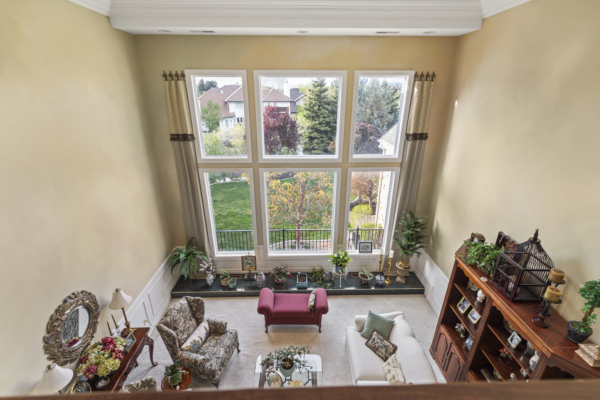 Living area featuring crown molding, carpet, and plenty of natural light