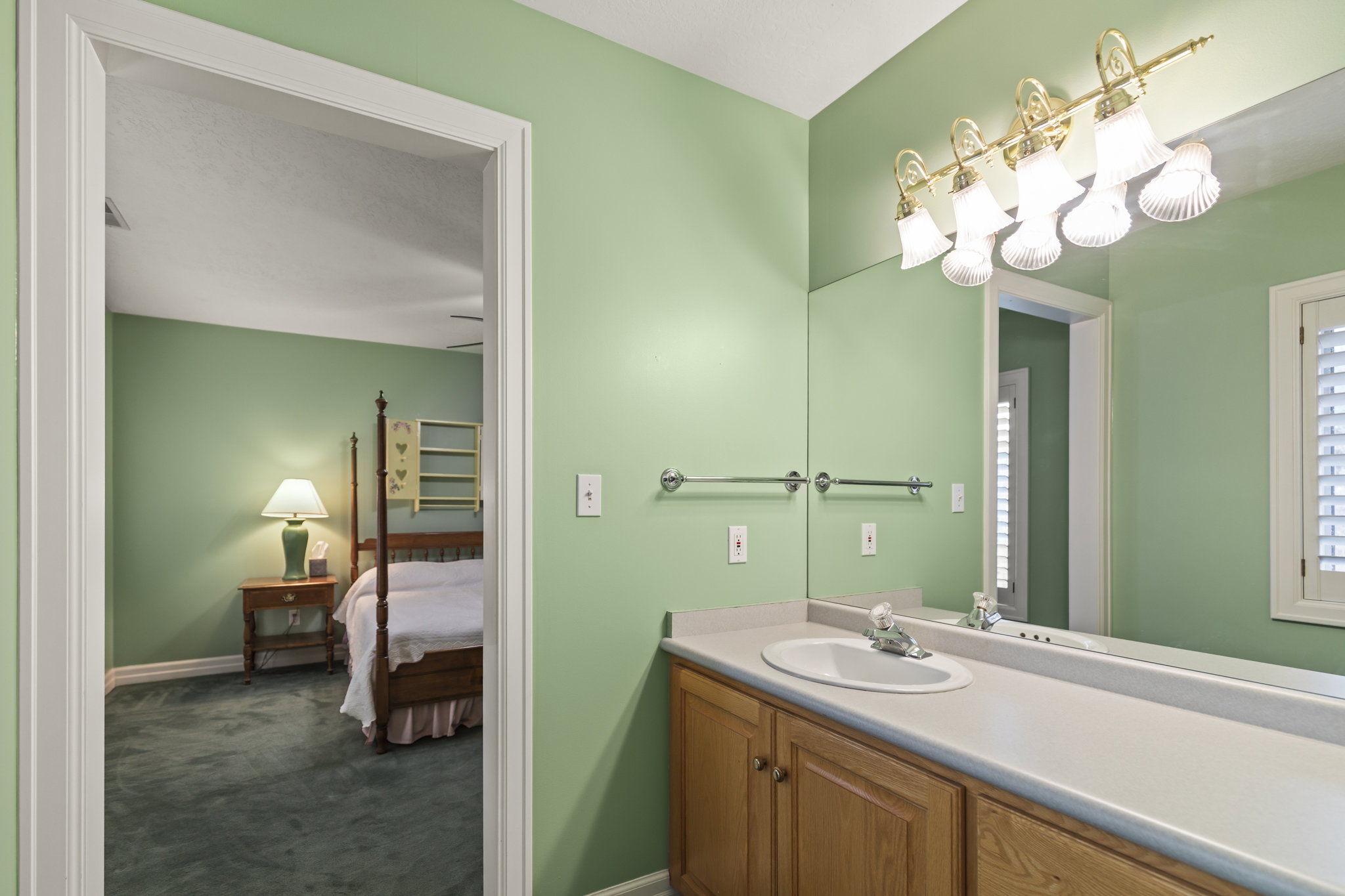 Ensuite bathroom with vanity and dark colored carpet