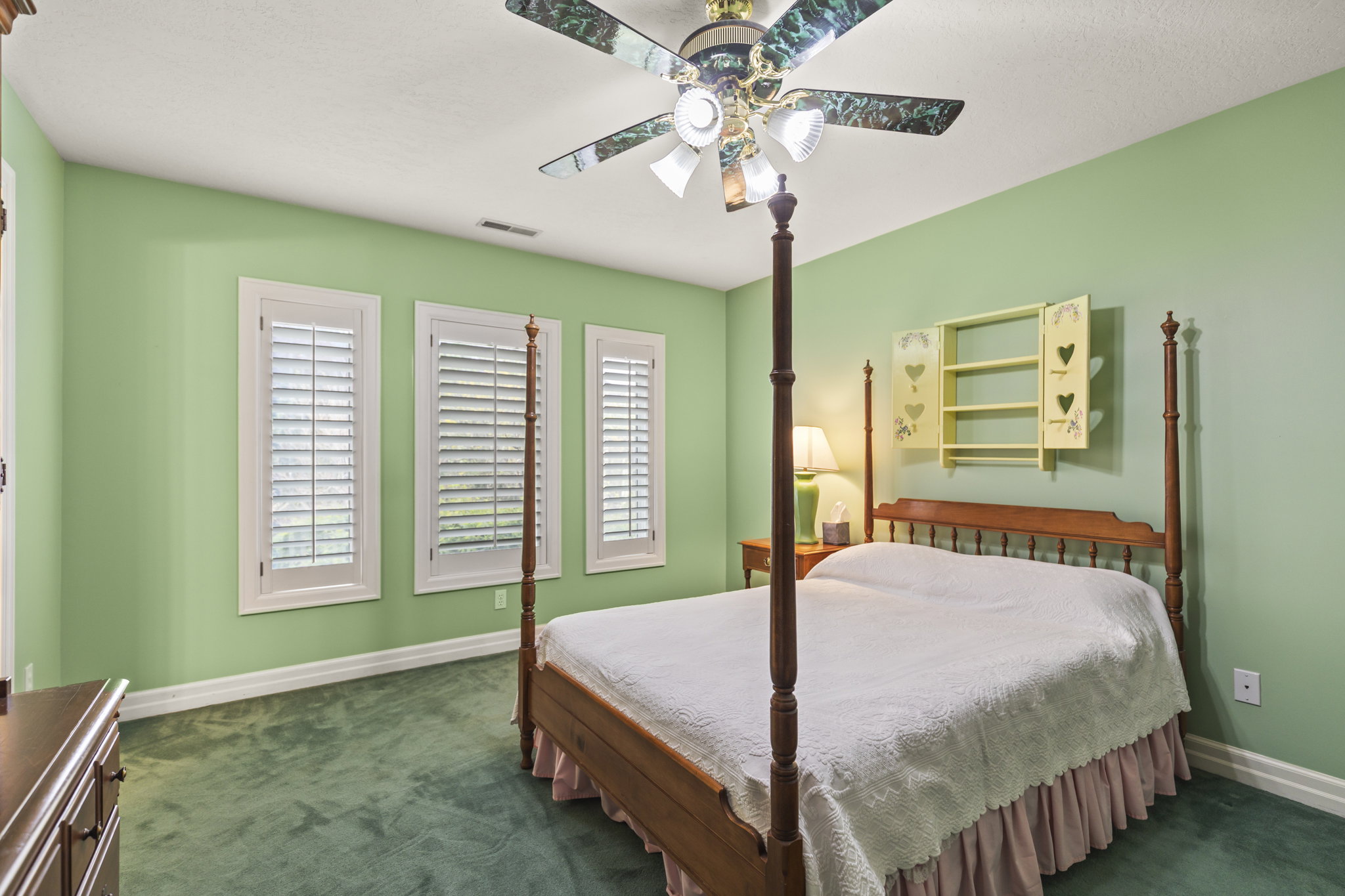 Bedroom featuring dark carpet and a ceiling fan