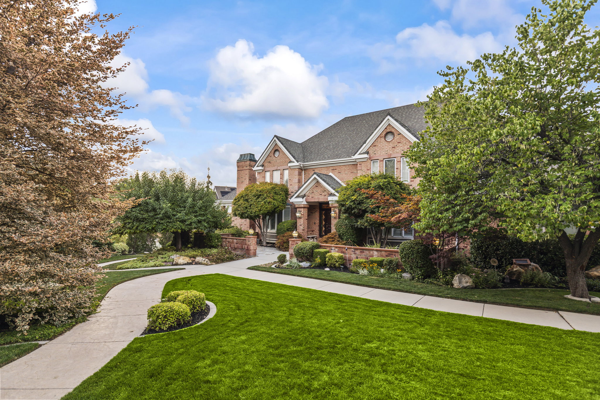 View of front facade featuring a front lawn and brick siding
