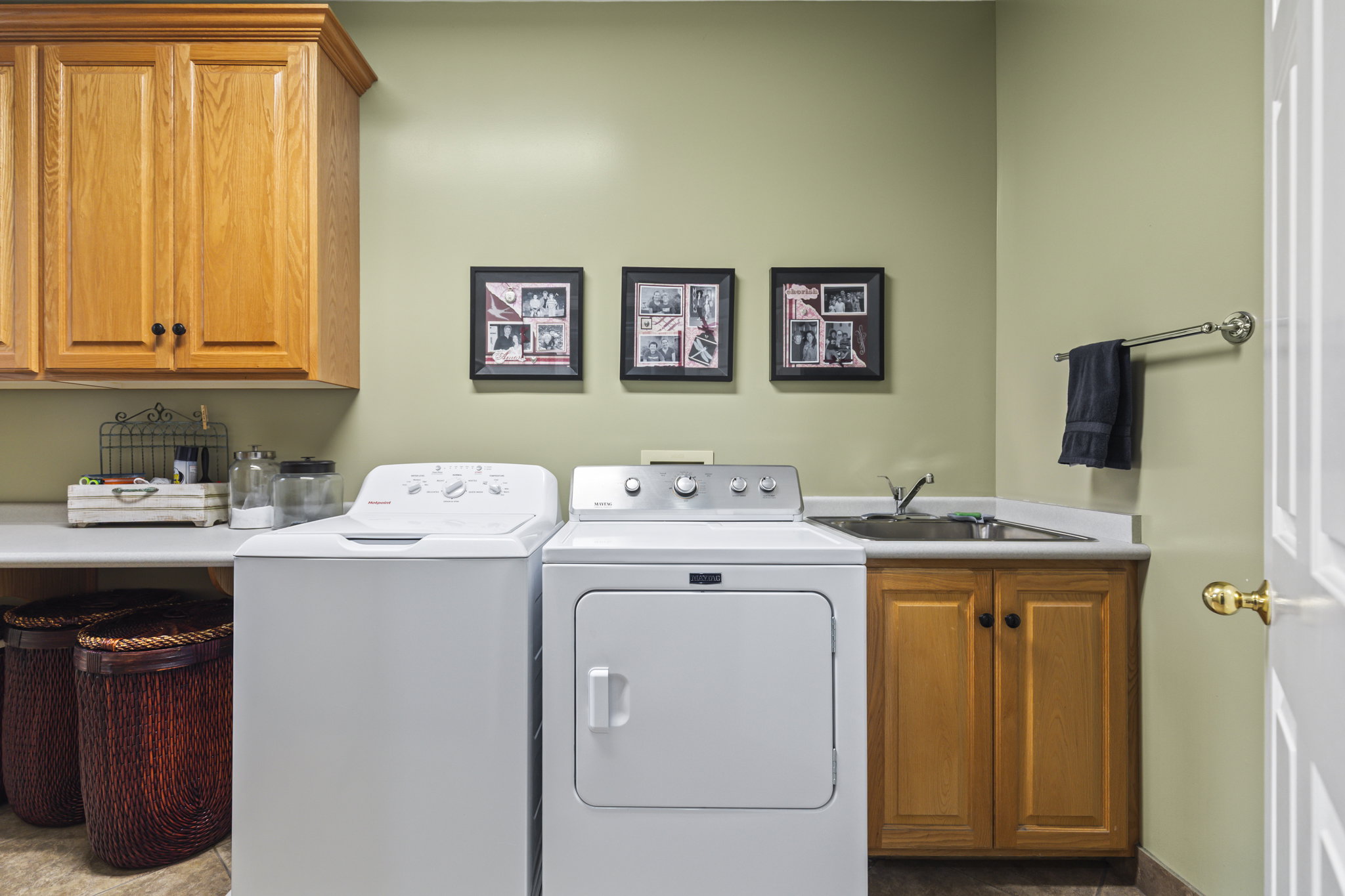 Laundry room featuring washer and clothes dryer and cabinet space
