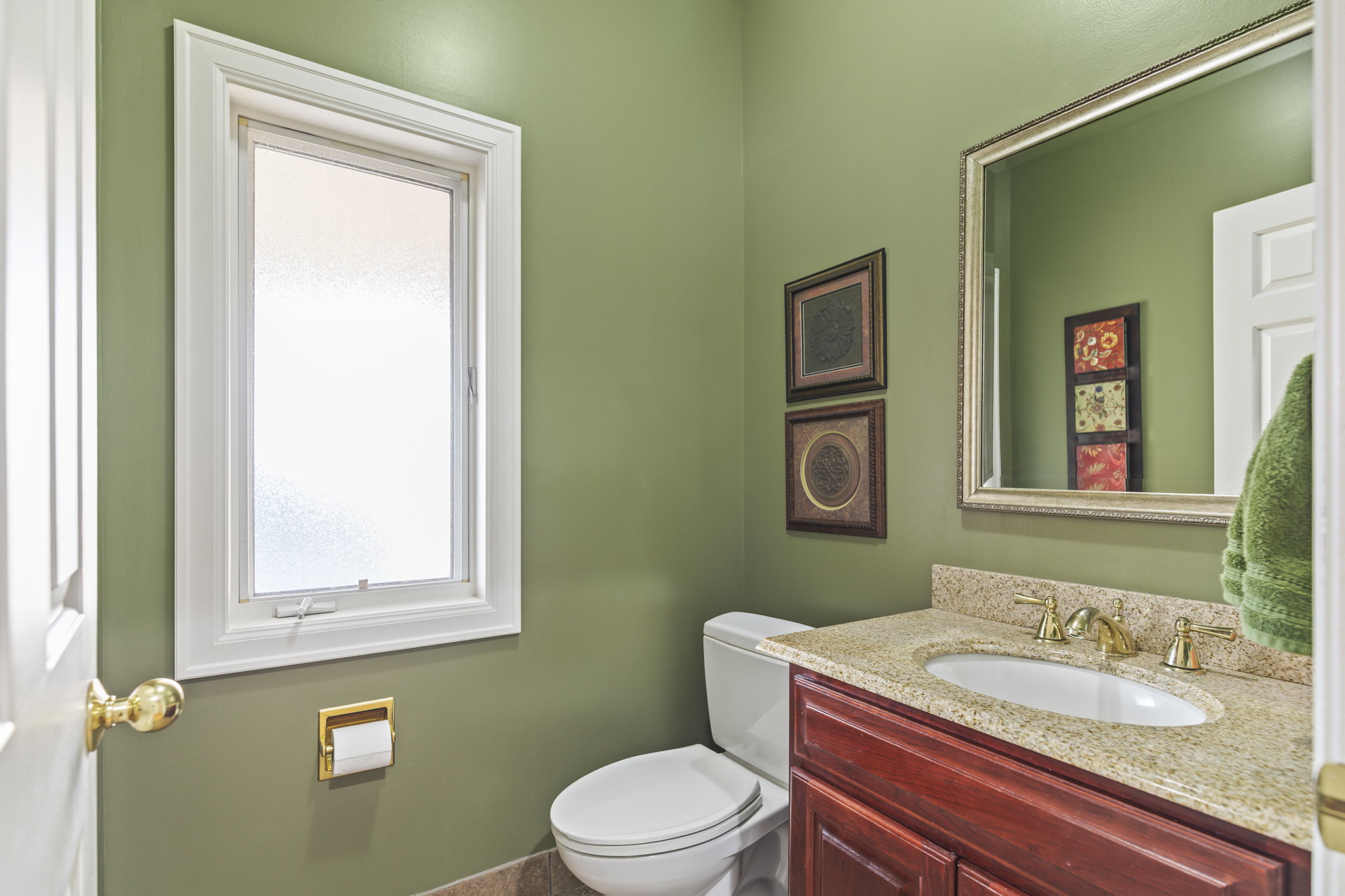 Half bath featuring toilet and vanity