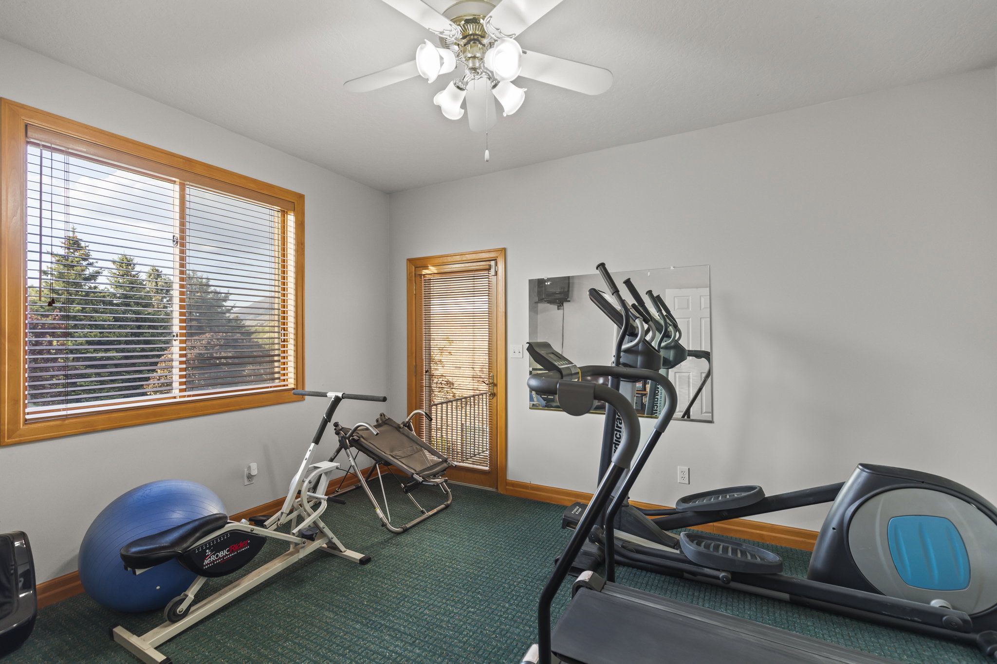 Workout area featuring ceiling fan and baseboards