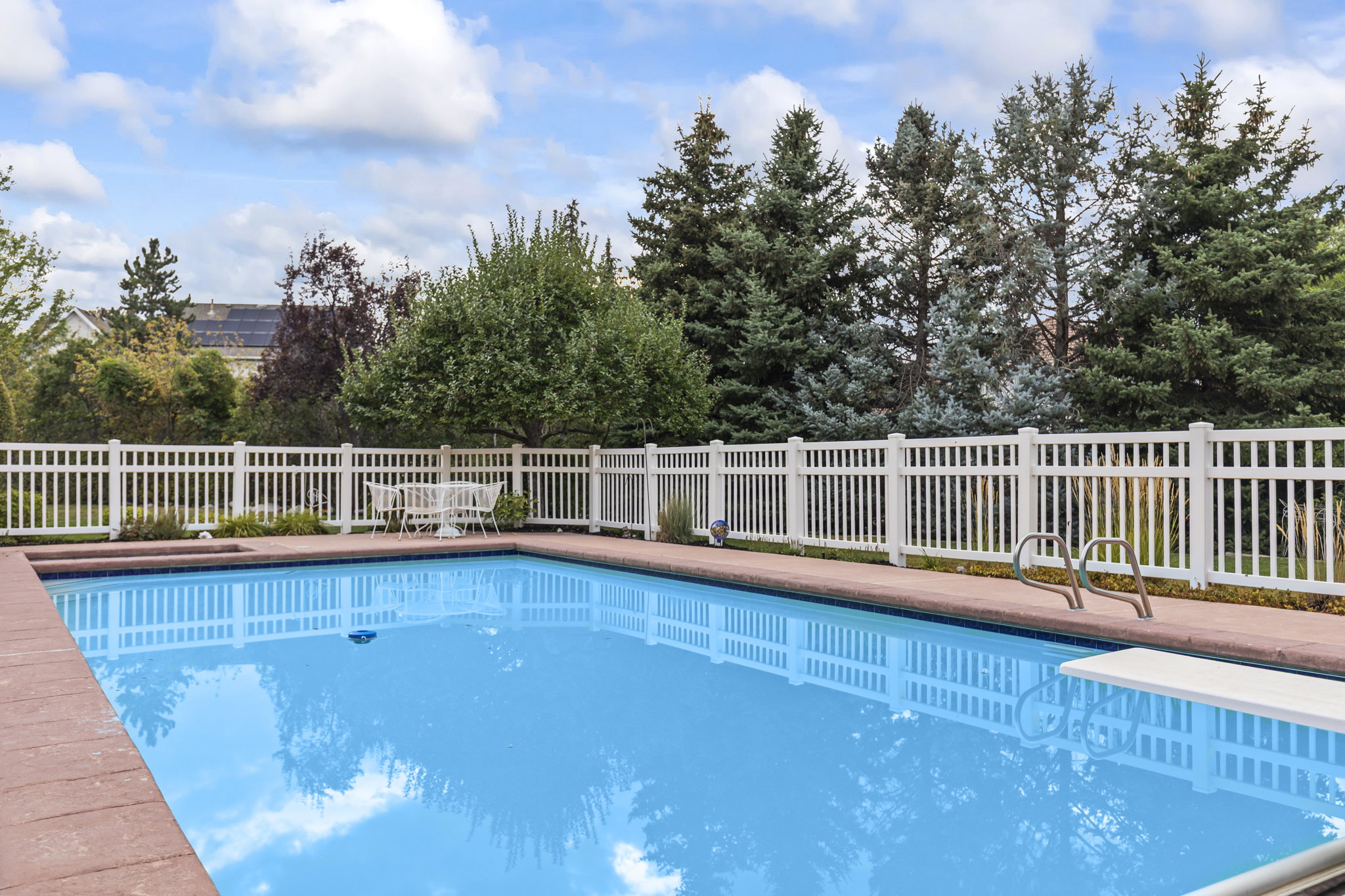 View of swimming pool with a diving board