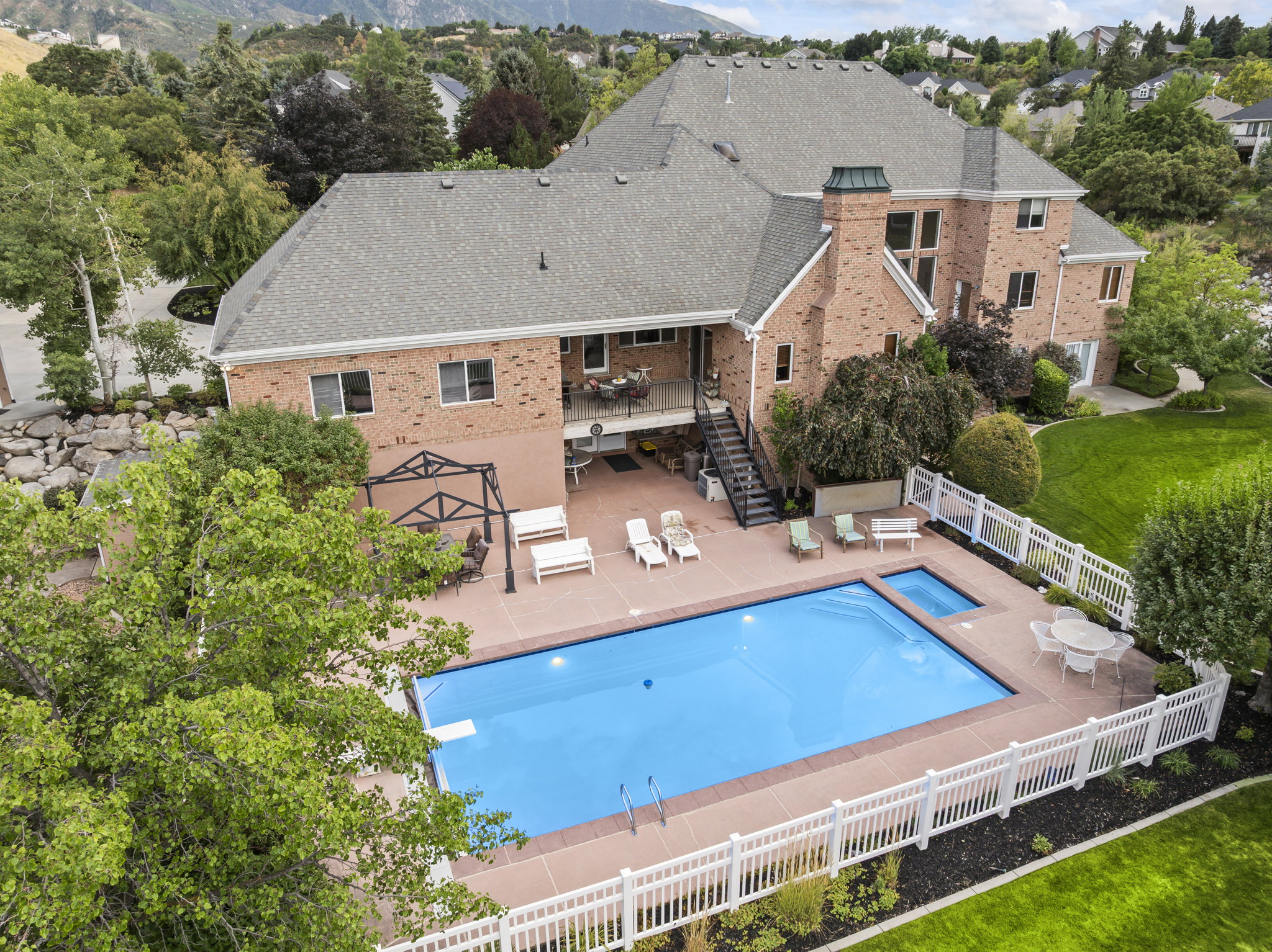 View of swimming pool with patio surround, a fenced backyard, and outdoor dining space