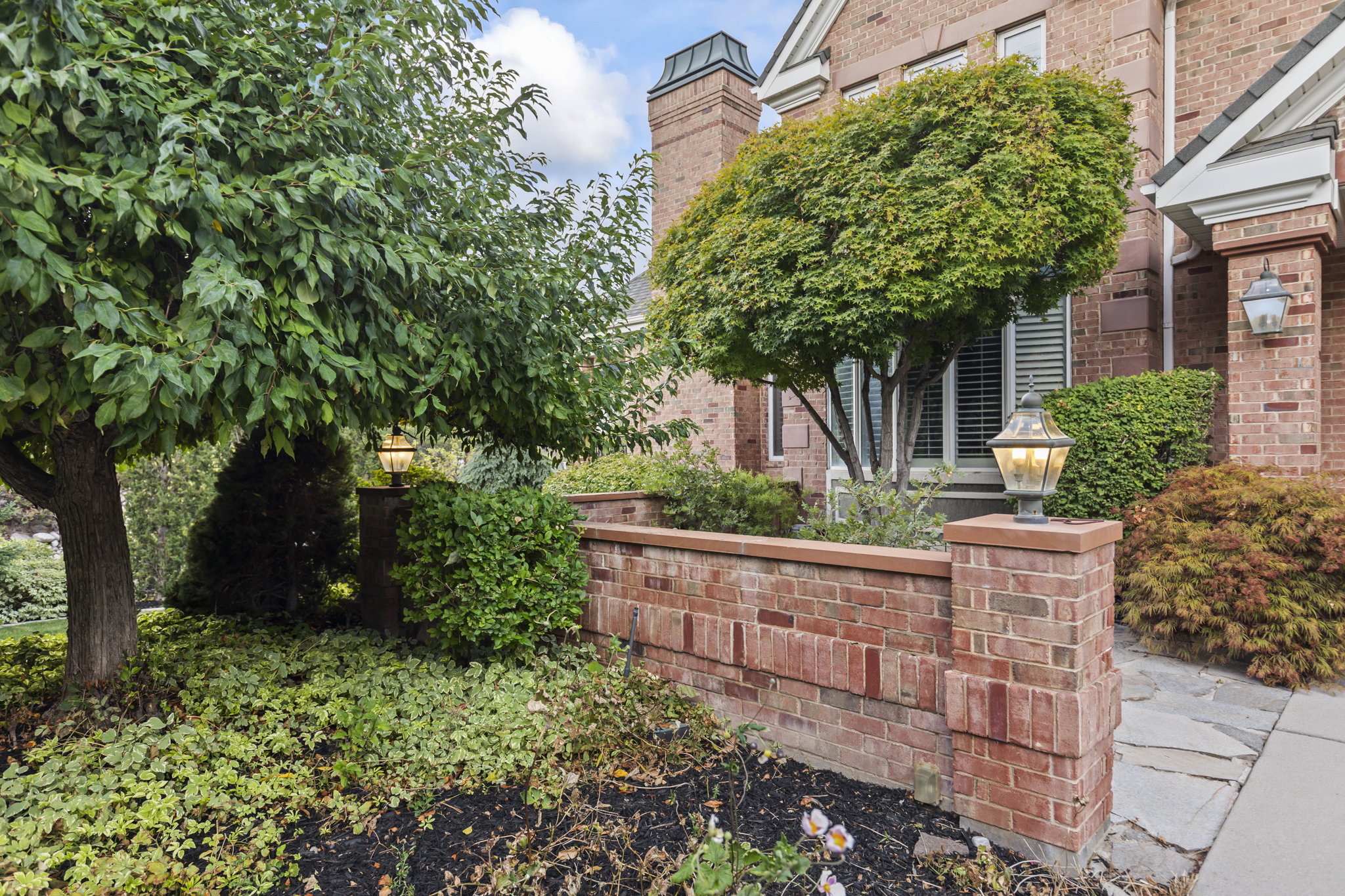 Exterior space featuring brick siding and a chimney