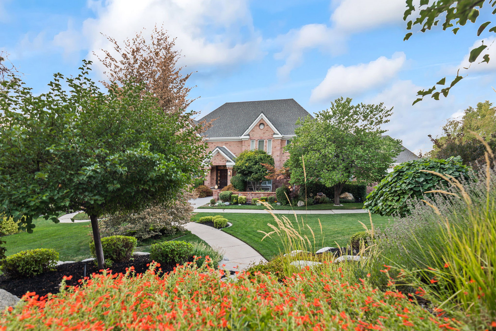 View of front of house featuring brick siding and a front lawn