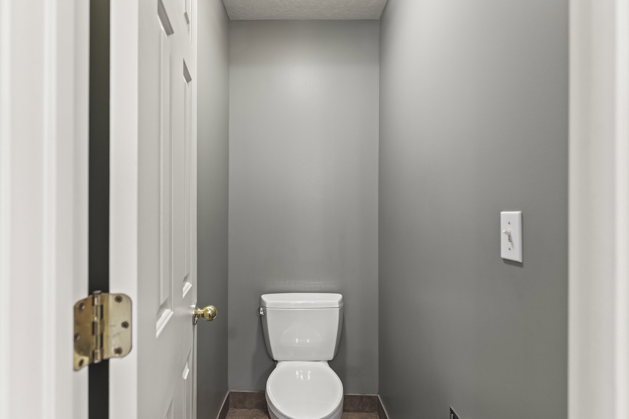 Bathroom with toilet and a textured ceiling