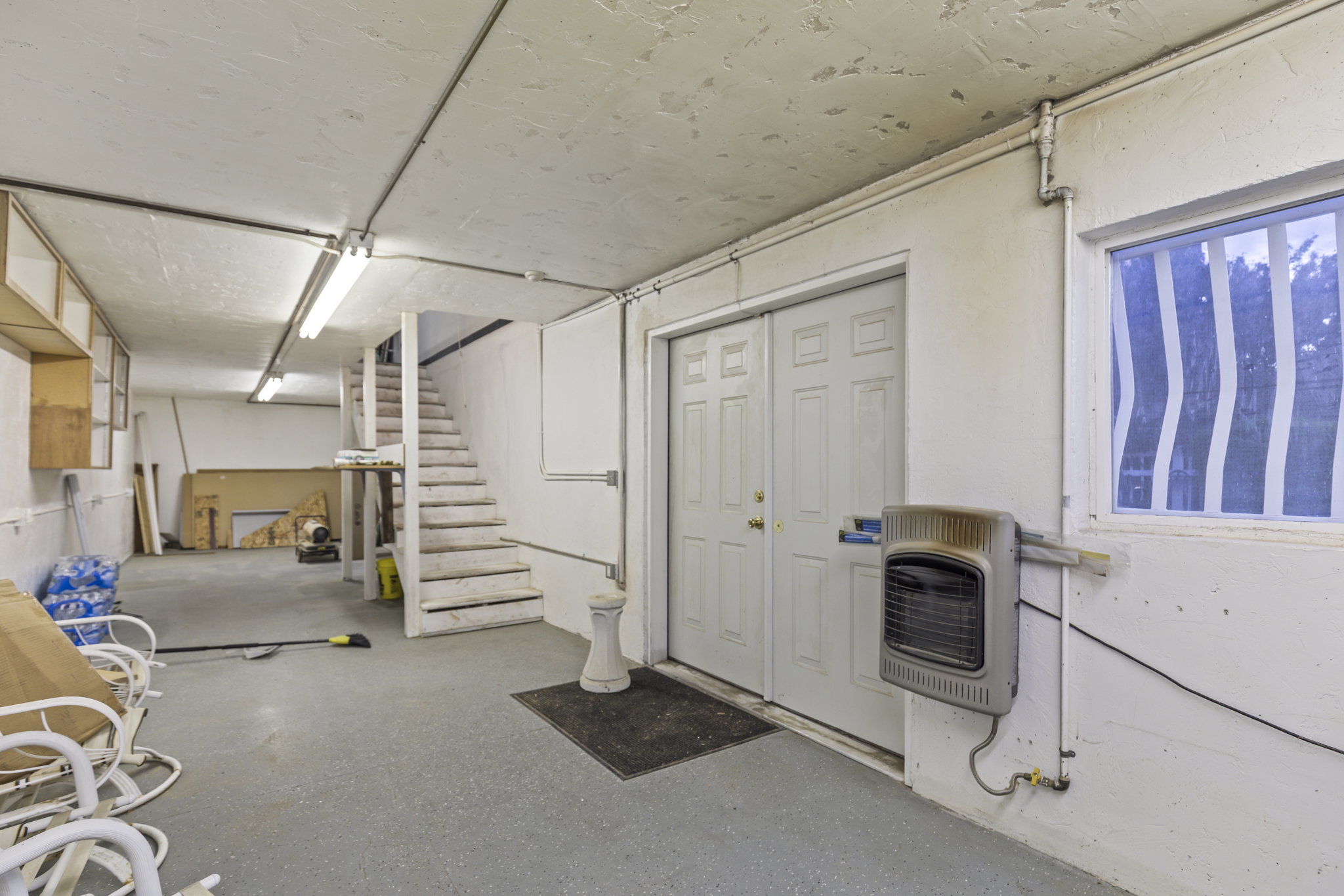 Basement with stairway and heating unit