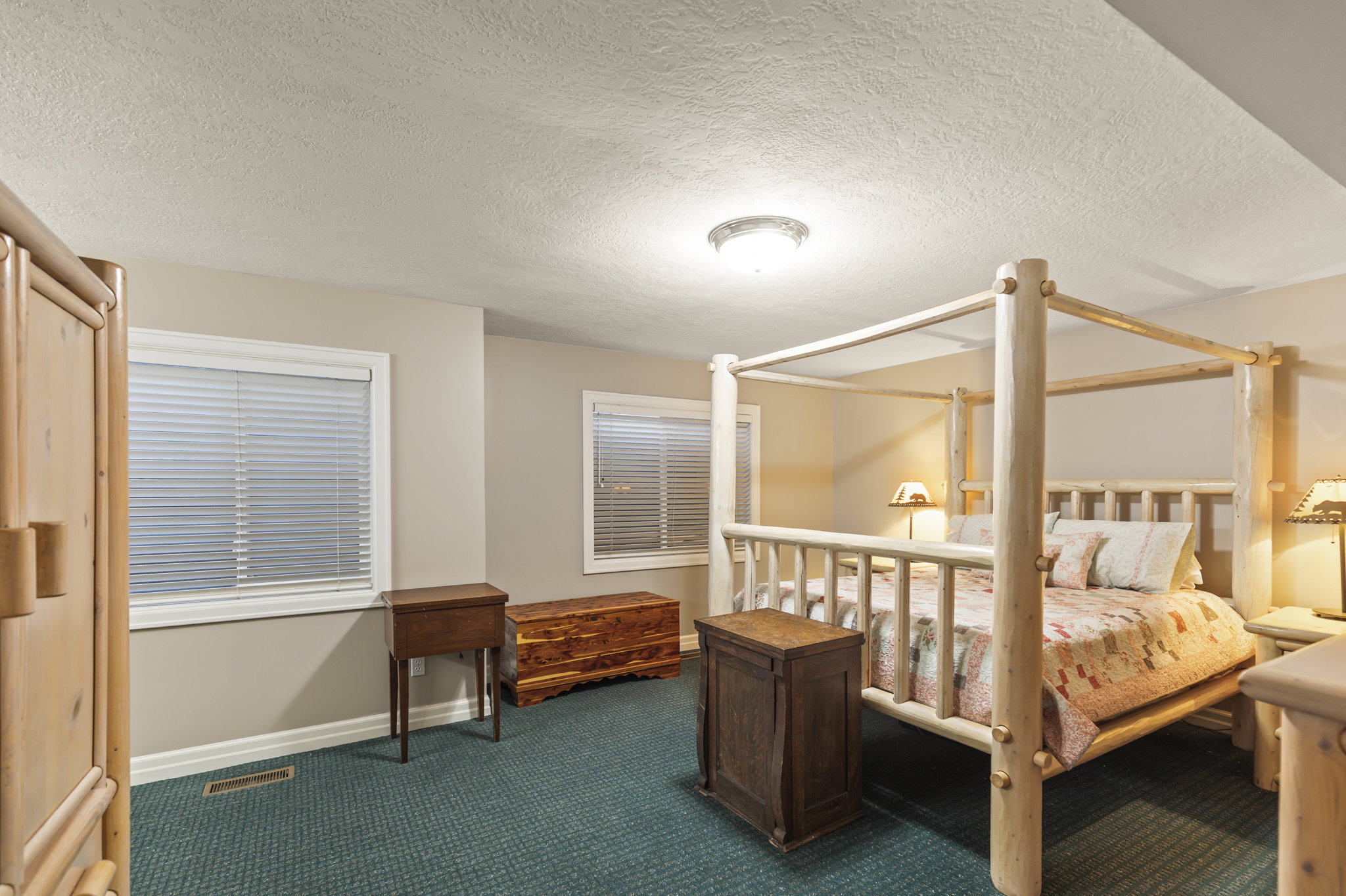 Bedroom featuring dark carpet and a textured ceiling