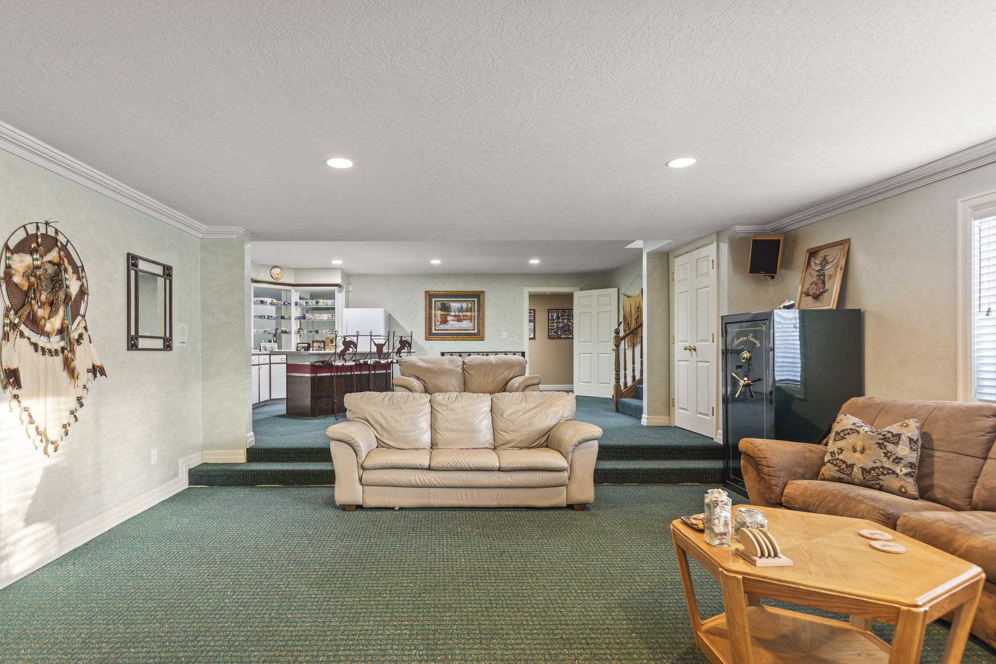Living area with crown molding, recessed lighting, carpet, and a textured ceiling