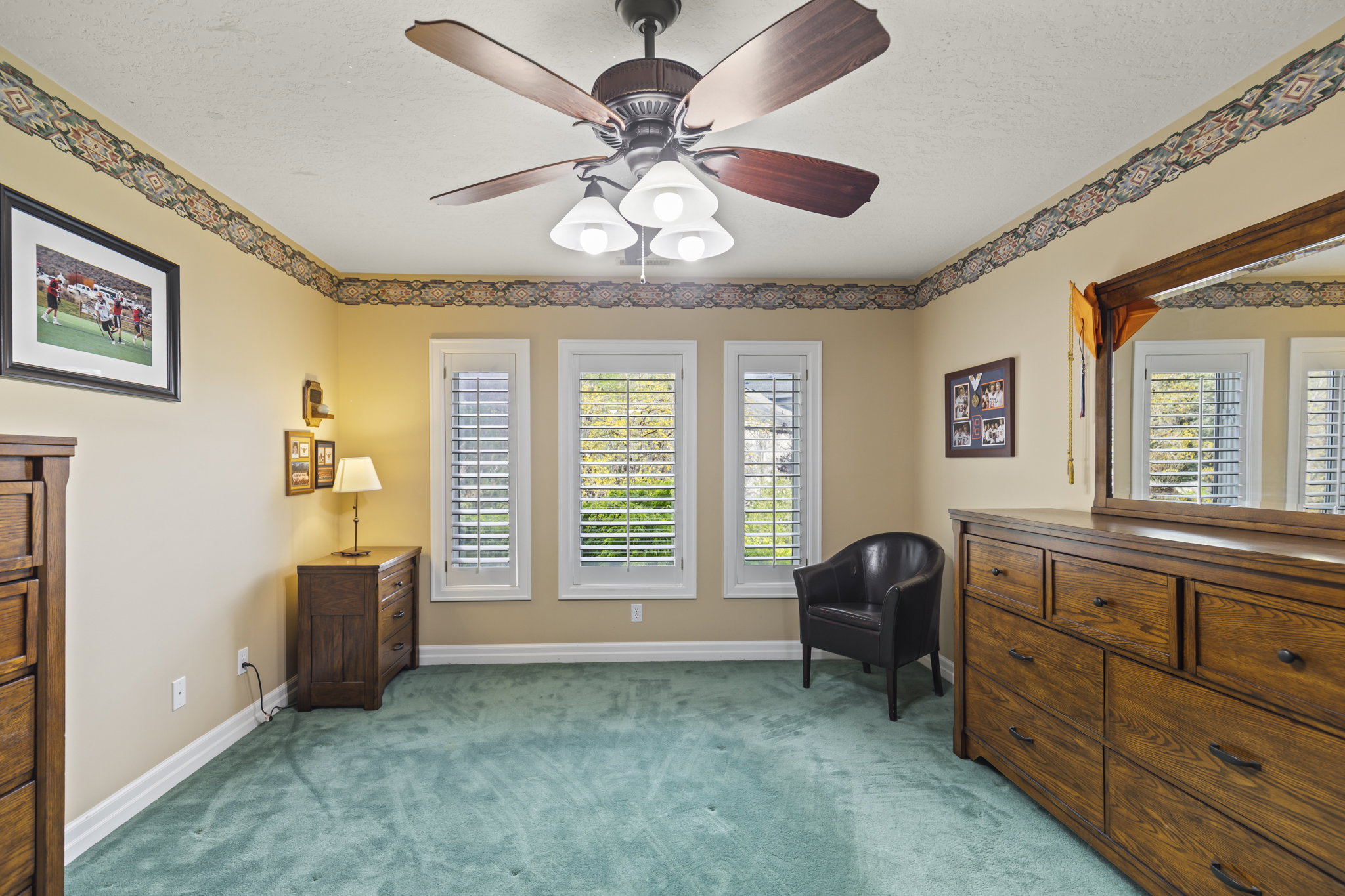 Sitting room featuring light carpet, a ceiling fan, healthy amount of natural light, and a textured ceiling