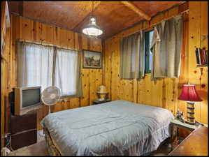 Paneled wood walls and sloped wood ceiling