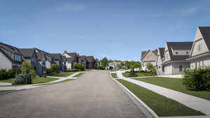 Street lined with properties featuring varied architectural styles and exterior finishes, including siding and stucco