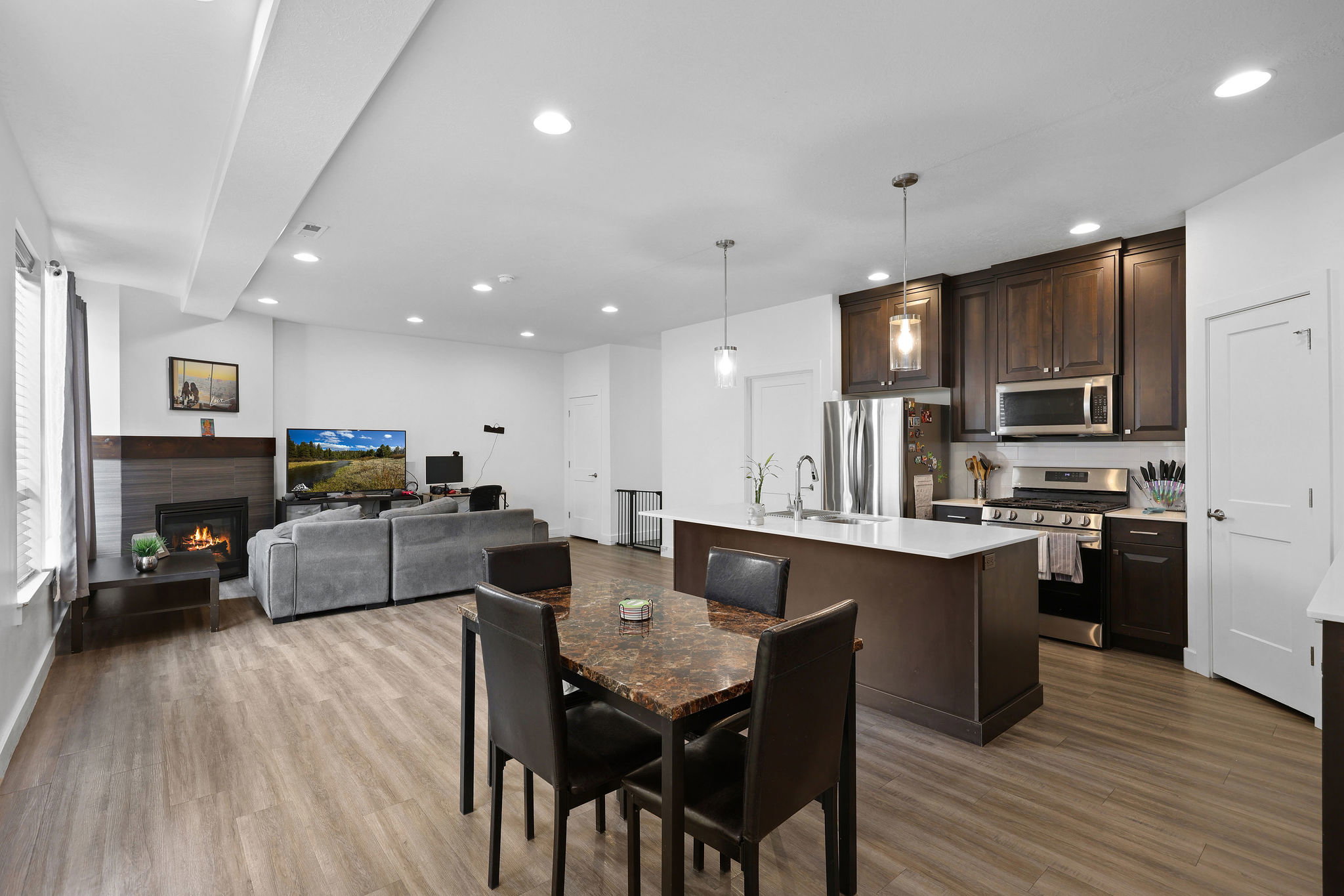 Open-concept main living area with wood-finish flooring
