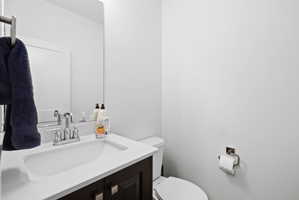 Bathroom vanity featuring a chrome faucet, integrated rectangular sink, and a light-toned countertop