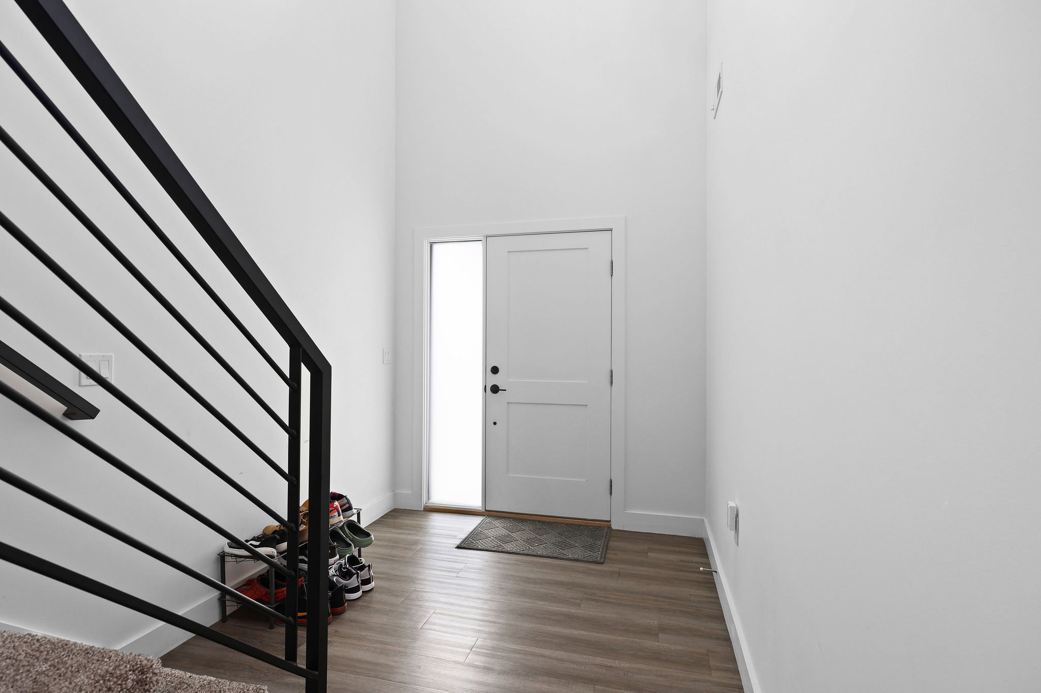 Entryway with wood-finish flooring and a white paneled door