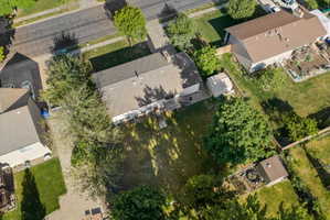 Expansive backyard featuring mature trees, a detached storage shed, and a privacy fence
