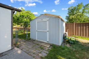 Outdoor storage shed with a light blue finish and white trim