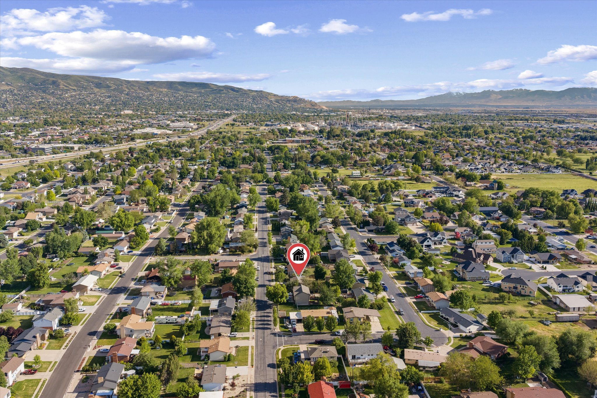 Aerial view showcasing a residential neighborhood with established streets and mature trees