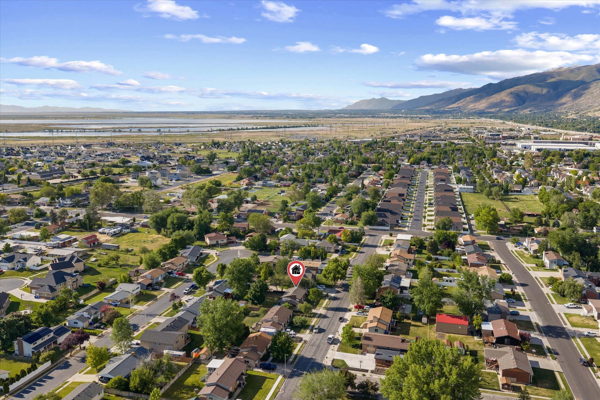 Aerial perspective showcasing a residential neighborhood with surrounding natural landscapes