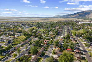 Aerial perspective showcasing a residential neighborhood with surrounding natural landscapes