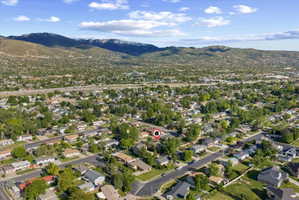 Aerial overview showcasing a residential neighborhood with distant mountain ranges