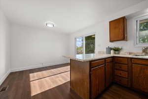 Kitchen area featuring wood-finish flooring and white walls